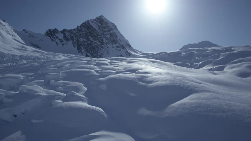 Aerial panorama of snow layers with mountains in the background