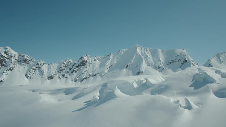 Aerial view of mountain ranges with layers of snow