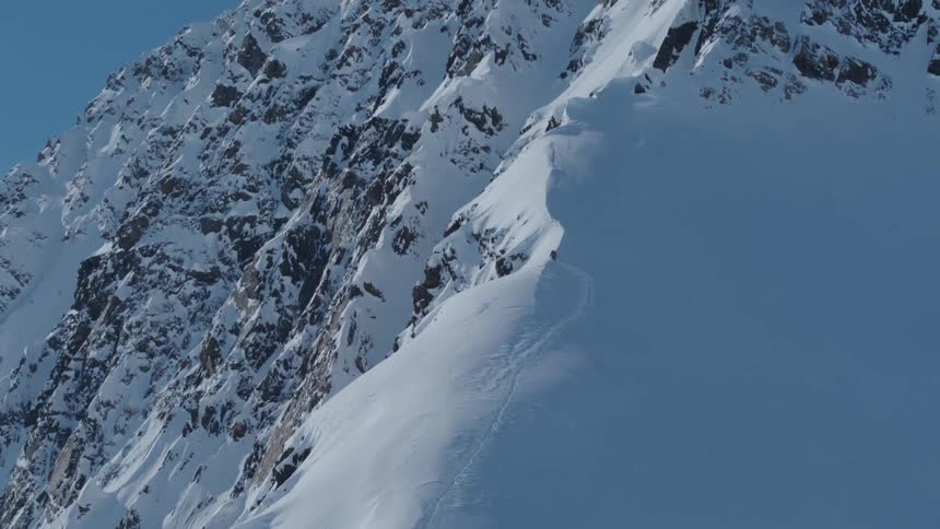 Aerial view of weathered and snowcapped mountains