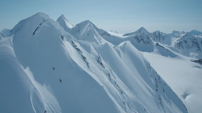 Pure white snow covers the mountain range