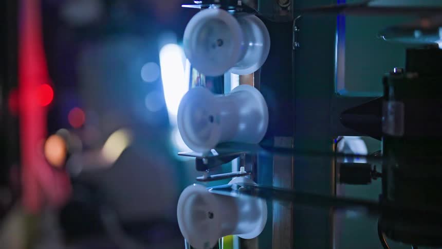 Close up of a vintage machine with film reels in motion