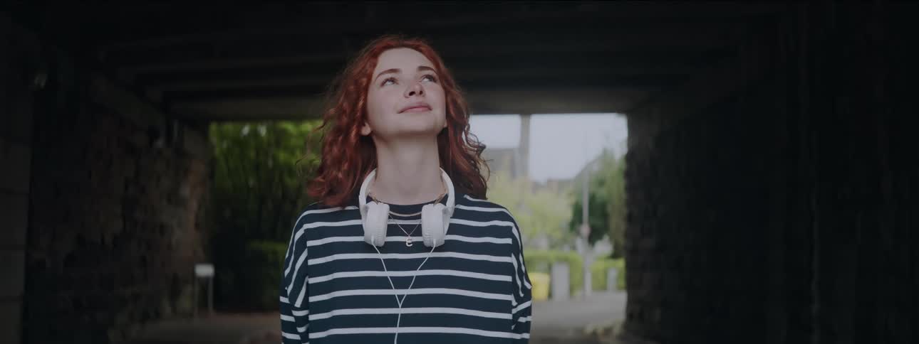 Redhead woman looking up with happy facial expression