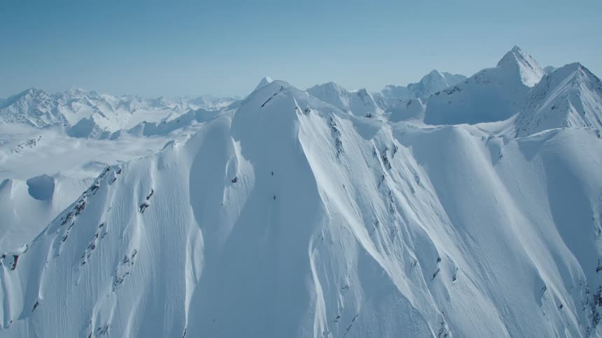 The mountain range is completely covered in snow