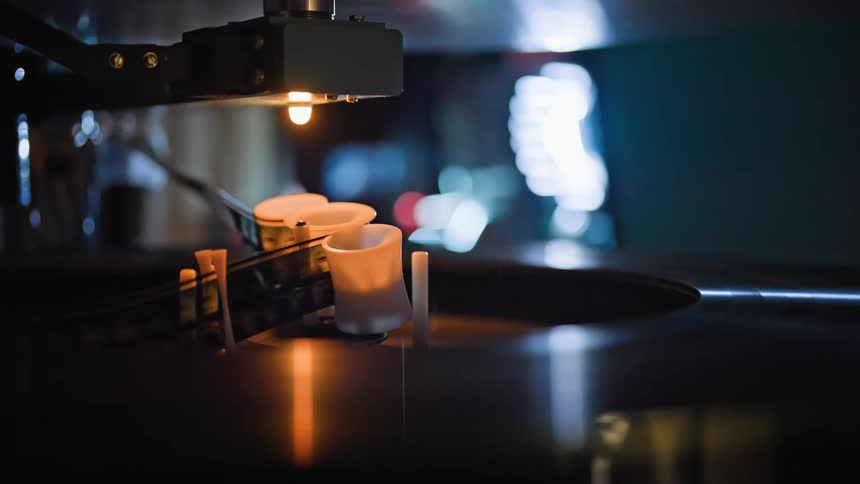 Film spools through a projector as an employee moves by