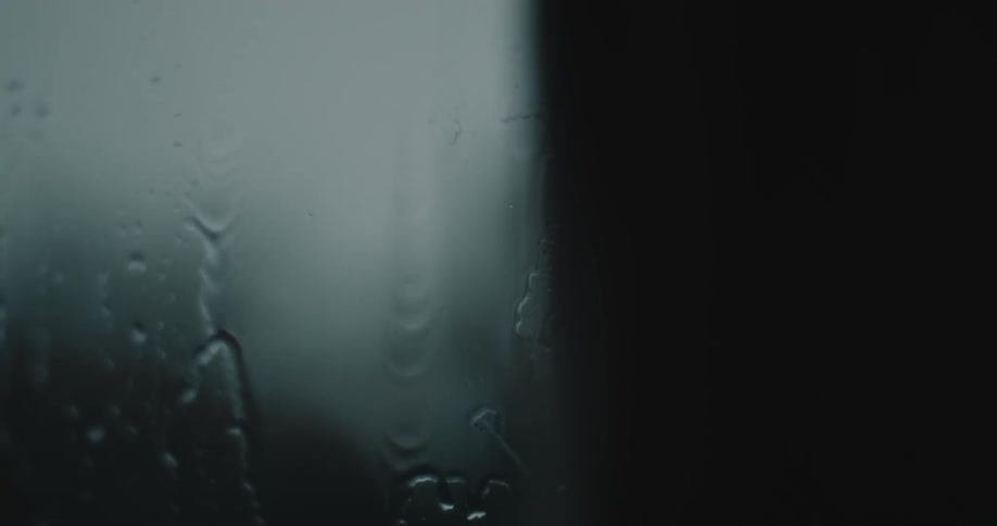 Close up of a window with rain running down