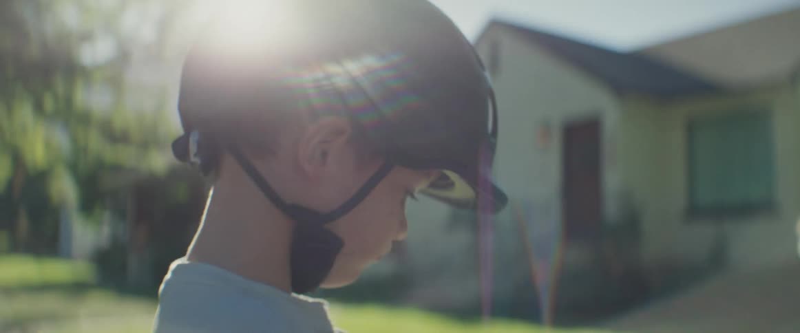 A father convinces his young son to get on a bike