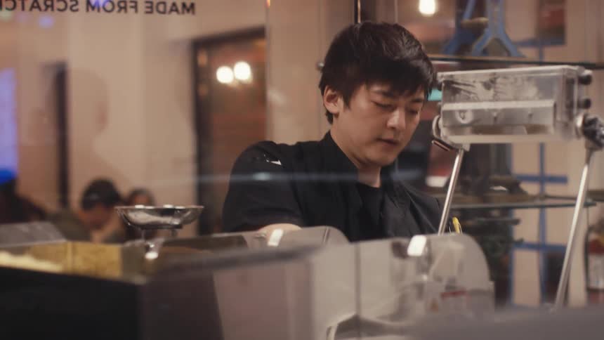 Male Chef using a machine in a restaurant