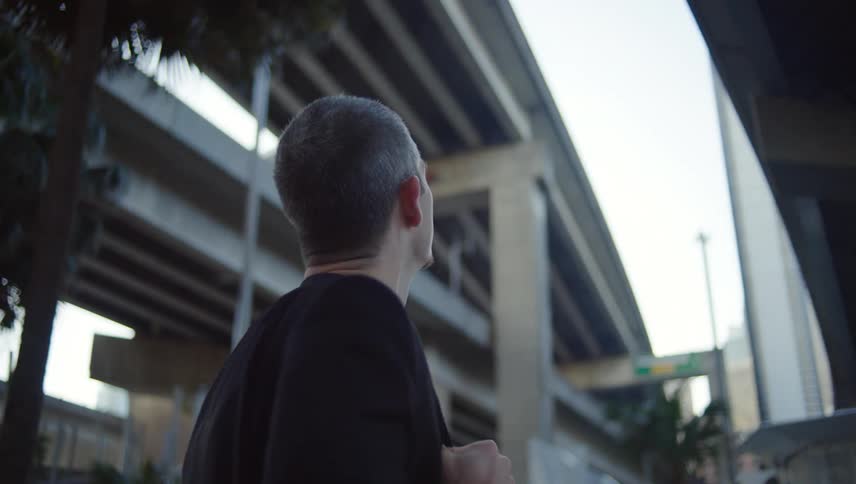 Man below an overpass looking up