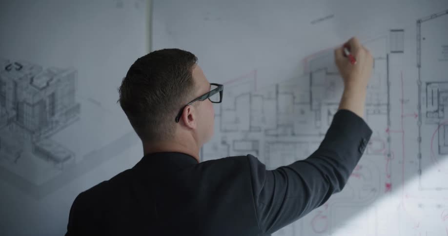 The architect is drawing a blueprint