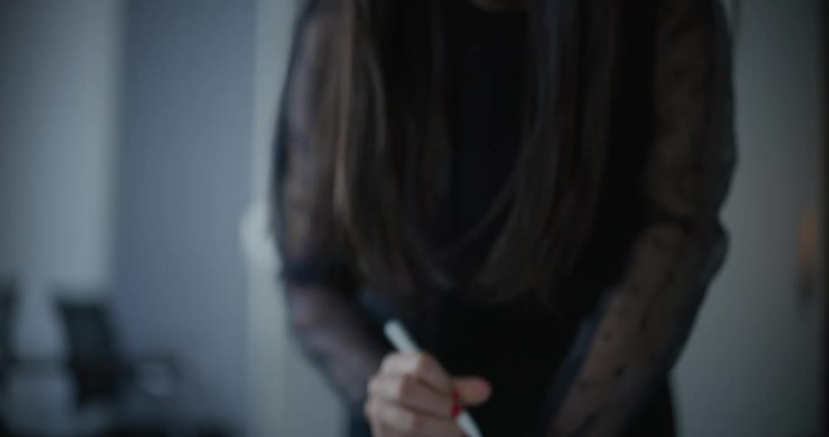 Woman talks while marking up a paper diagram lying on a table