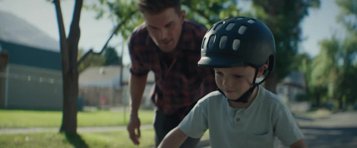 Father teaching his son to ride a bike