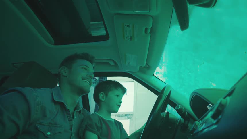 Father with his little son inside the car and inside a washing machine