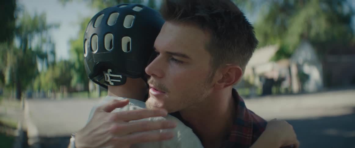 Father hugging his little son wearing a helmet
