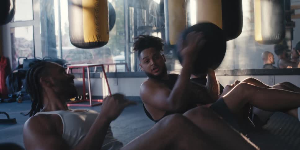 Four men passing a weighted medicine ball to each other and having fun