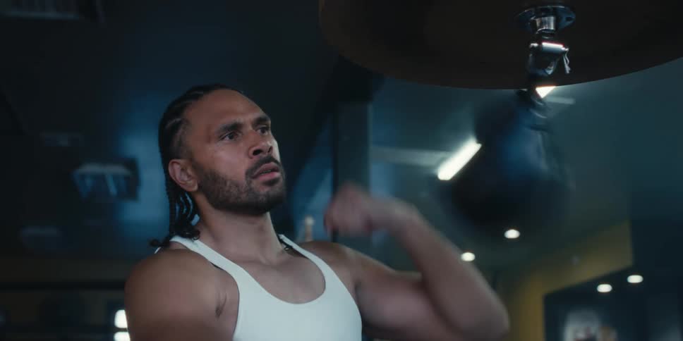 Man punching a speed bag in a boxing gym