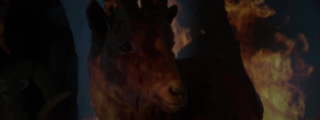 Burning flames appear over a horned animal who is slowly moving forward