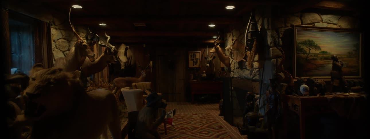 A dimly lit room filled with taxidermied animals and hunting trophies