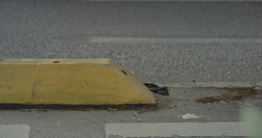 A close up clip of the road with car tires moving