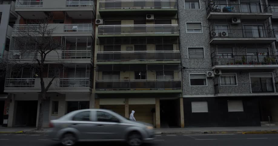 Urban buildings facing a street with vehicle traffic