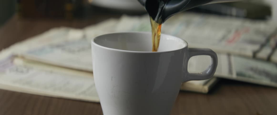 A close up clip of a coffee being served on a desk