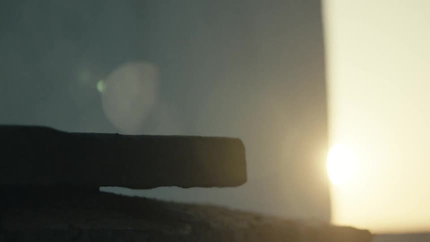 A blackened wood plank smoking in the sunlight