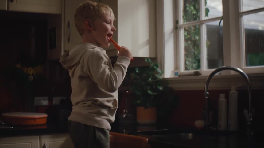 A child brushes his teeth at home
