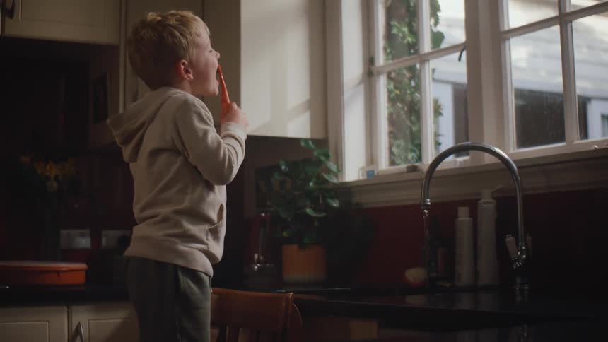 A clip of a young child brushing beside the window