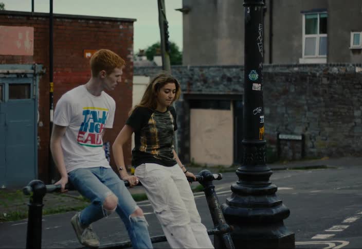 A young couple sitting together outside