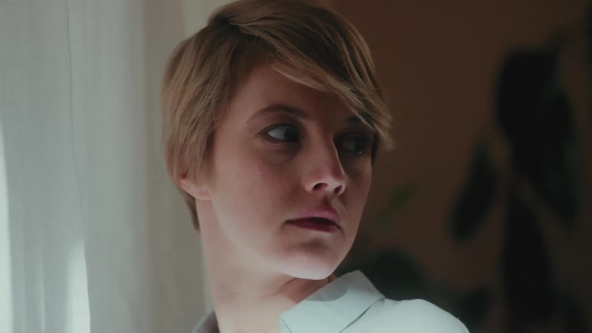 Woman turns to look over her shoulder