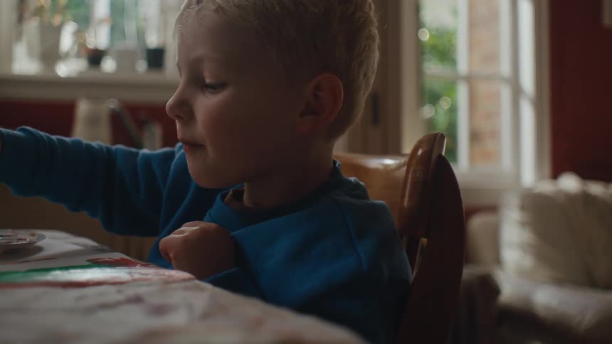 A young boy paints