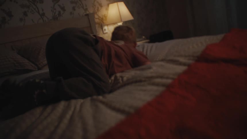 Child playing jumping on the bed and throwing himself