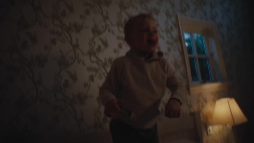 Little boy jumping on the bed and throwing himself