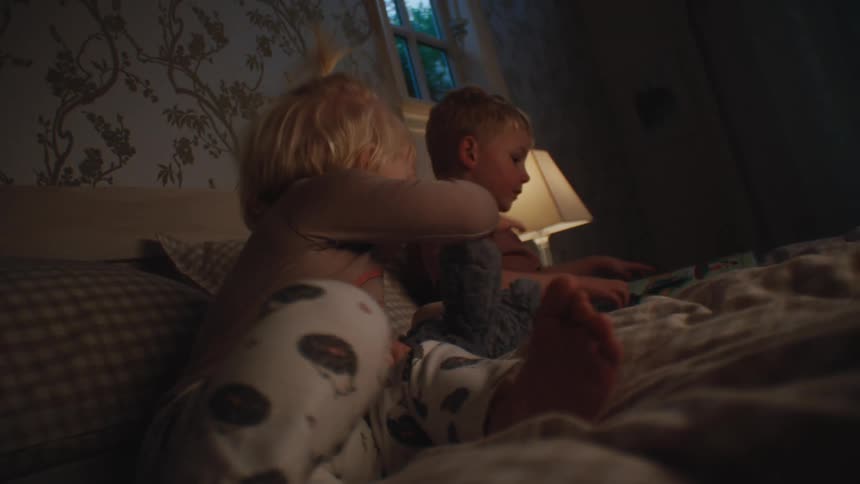 Siblings move around in bed