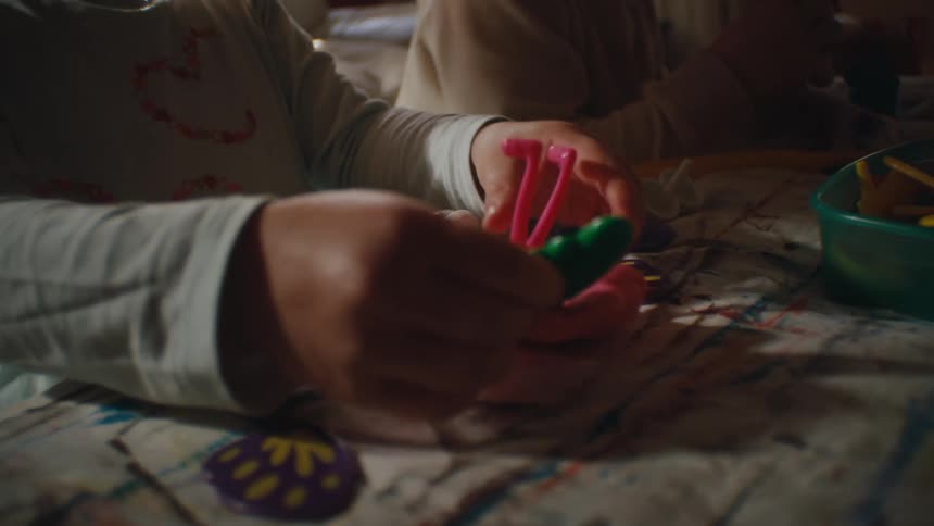 Children are taking apart toys on the table
