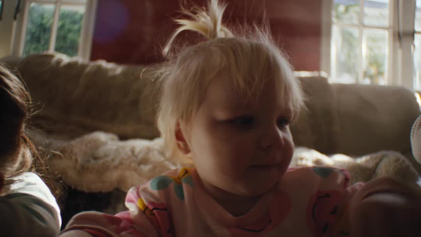 Portrait of a little blonde girl in the living room