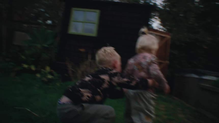 Two small children playing in the garden