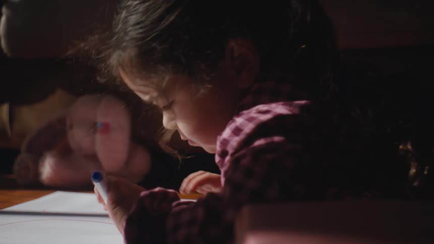 A child is drawing on paper