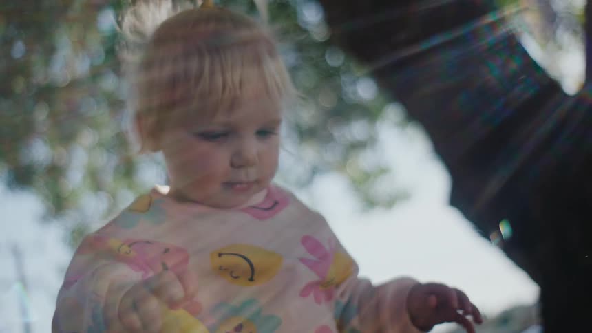 A baby is blowing bubbles