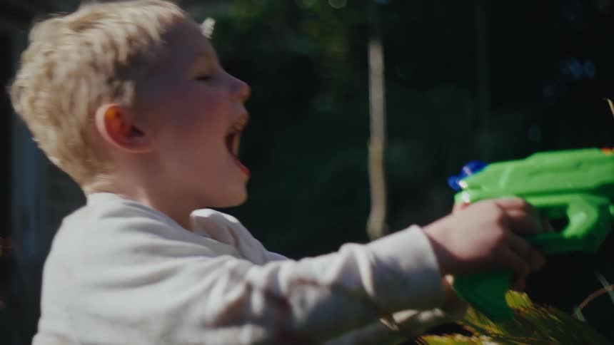 Boy playing with a water gun