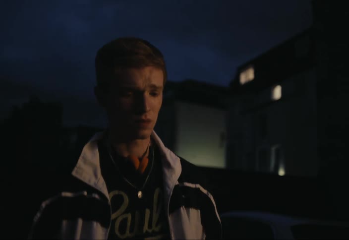 Young teenager walking down the street at night