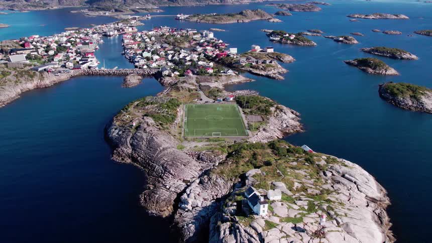 An aerial view of a small island with a soccer field in the center