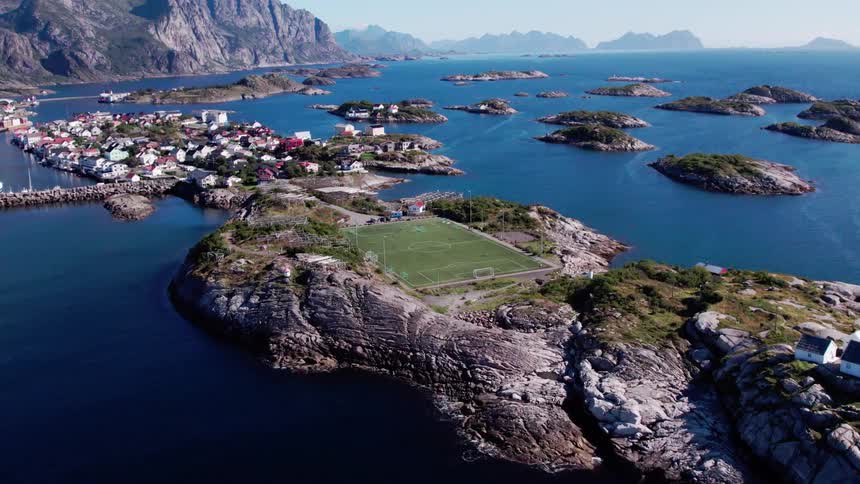 Aerial view of a soccer field on an island surrounded by the sea seen during the day