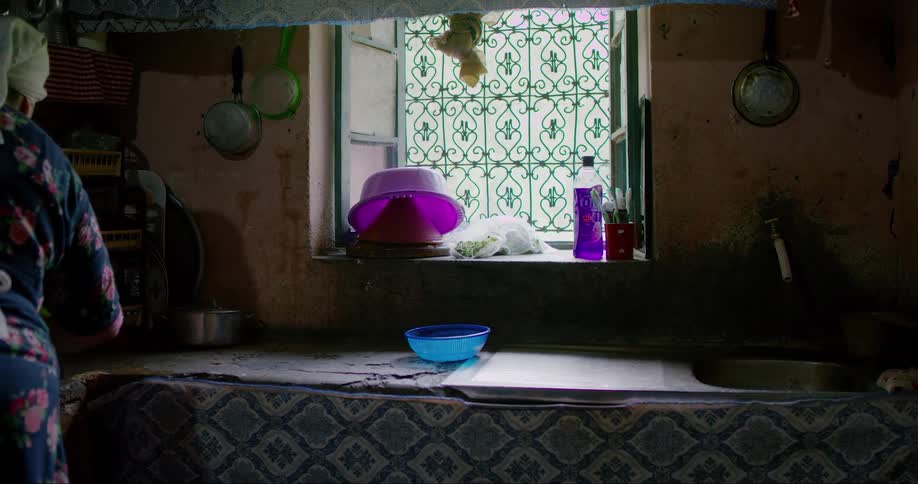 Woman with a towel on her head is in the kitchen