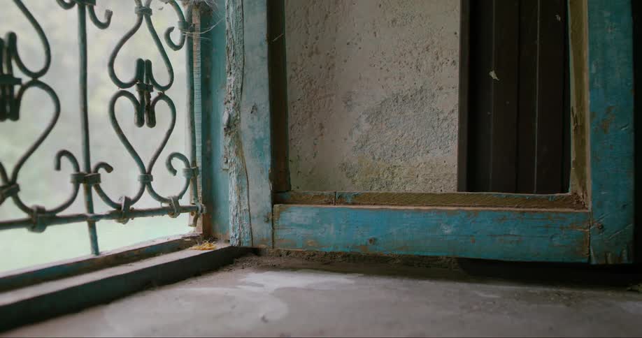 Open wooden frame sits perpendicular to an opening with an iron work covering
