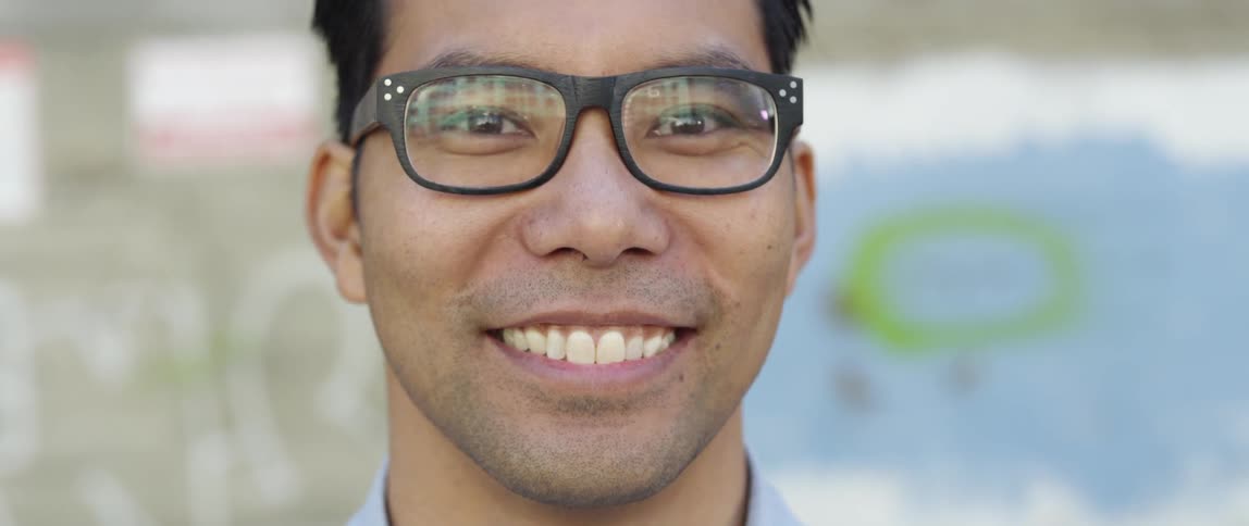 A man in glasses smiles