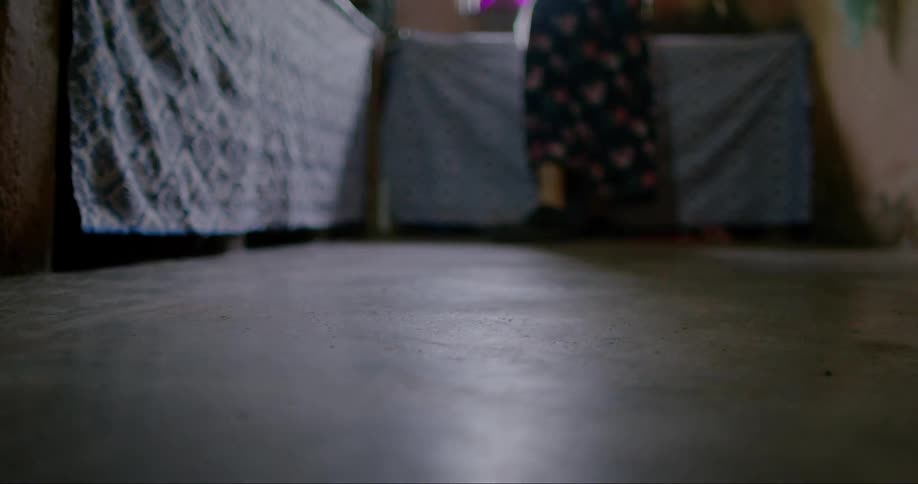 Legs of a person walking through a room in the house