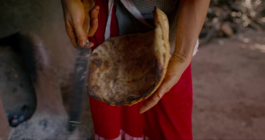 Person with a knife shaping dough