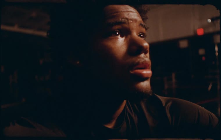 Portrait of a young man taking a deep breath while sitting