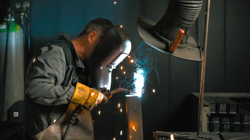 Man performing welding work on a metal structure