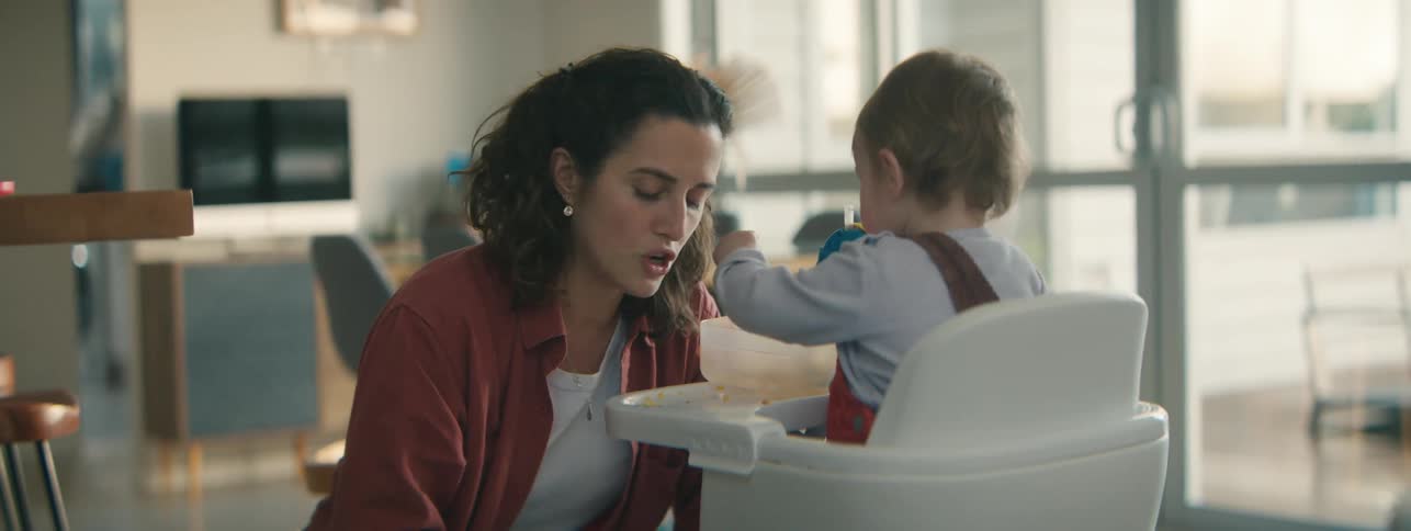 A mother is feeding her son